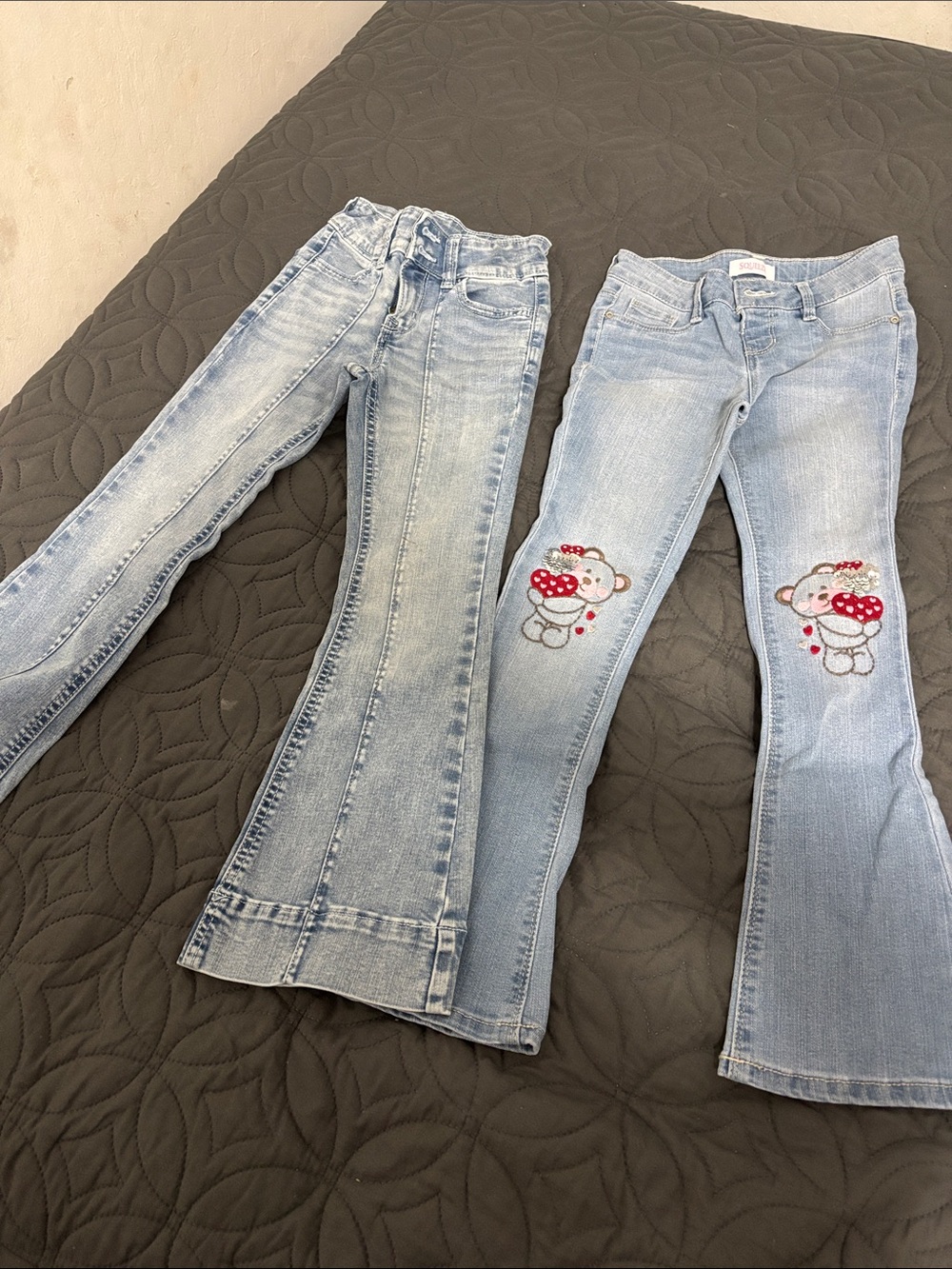Girls' Light Blue Embroidered Bear Flare Jeans and a pair of blue flare jeans.